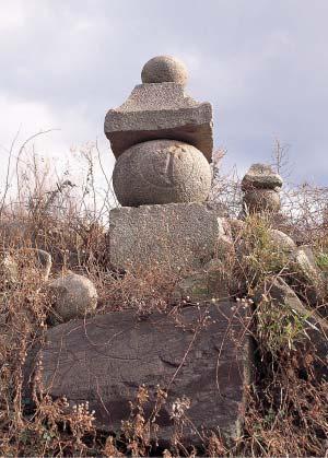 四角と、丸い石が交互に重なる五段の石の写真
